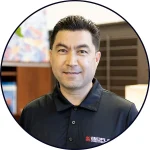 Portrait of Slava Kim, Director of Medical Operations at BIOFLEX Clinic and webinar speaker, wearing a black clinic polo shirt.